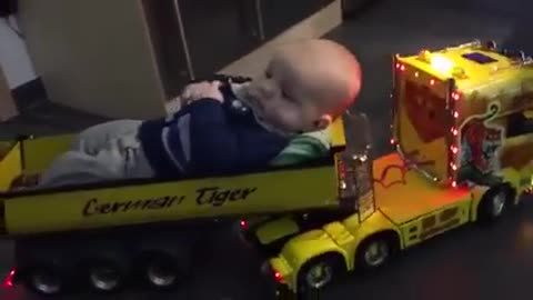 A sleeping child in a truck