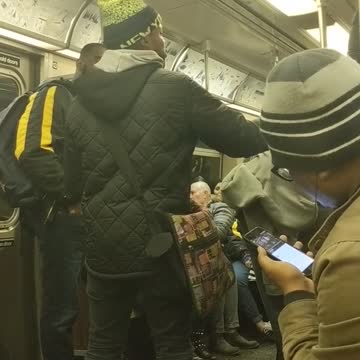 Orange beanie guy sings very well on subway