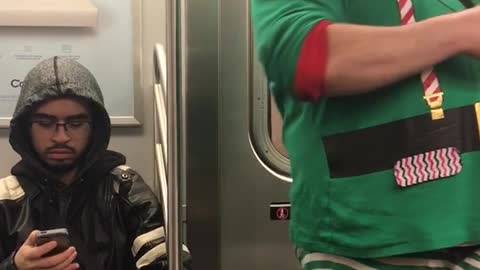 Man in elf outfit on subway train