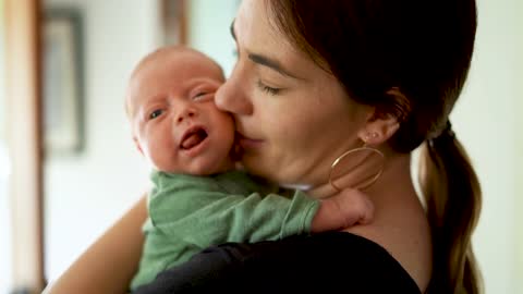 Mama kissing her baby