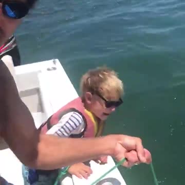 Little boy helps dad catch a lot of fishStarting early. 6-year-old Jack helps his dad,