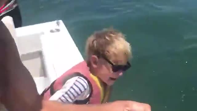 Little boy helps dad catch a lot of fishStarting early. 6-year-old Jack helps his dad,