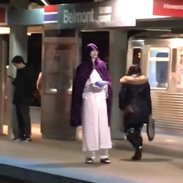 Man in white and purple robe outfit