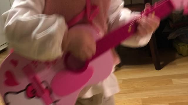 Baby playing guitar