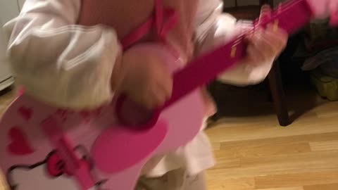 Baby playing guitar