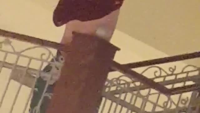 Guy on stairs can't put on red jersey