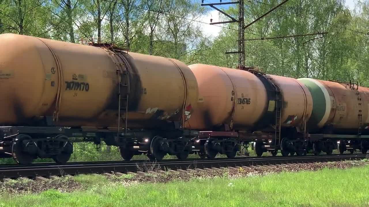 Cargo Train Passing by the Railway