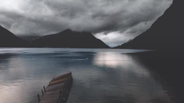 Time Lapse Footage Of Clouds Over A Lake And Mountains