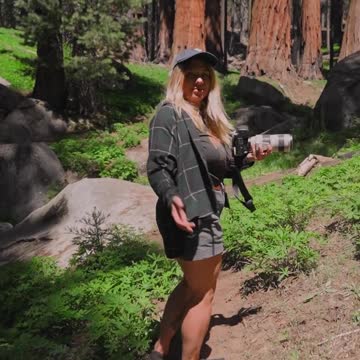 Back View of a Woman Walking in a Forest