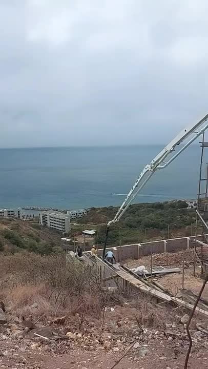 Construction with Concrete Truck on Hillside