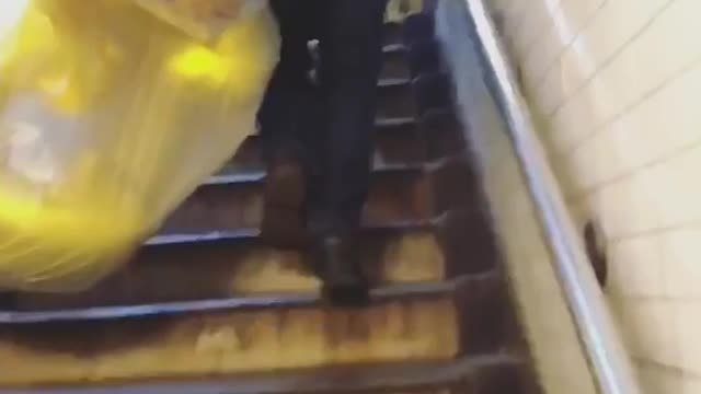 Man carrying balloons in bags through subway