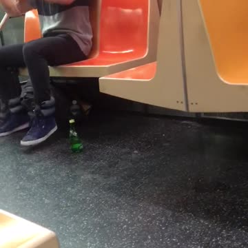 Long hair man air drums on subway