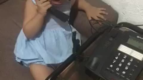 funny toddler talking over the phone