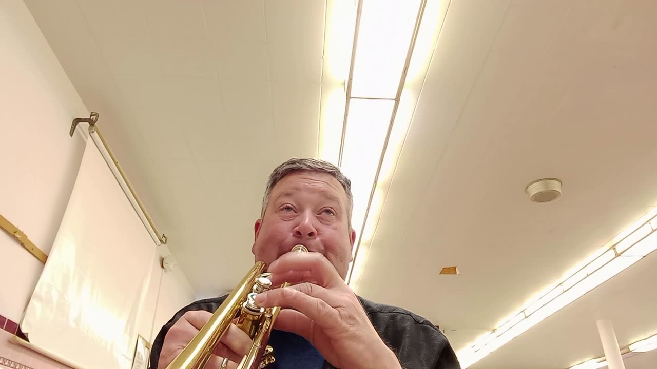 Checking out an old trumpet when a student walks in.