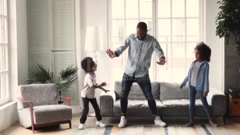 African dad dancing having fun with kids in living room ❤️