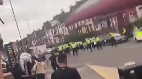 Police run away from migrant mob amid violent unrest in Leeds, England.