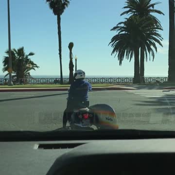 Motorcycle with a rainbow surf board