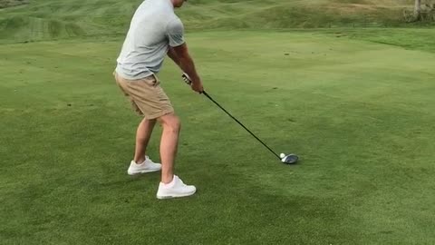 Guy grey shirt playing golf knocks out chunk of grass