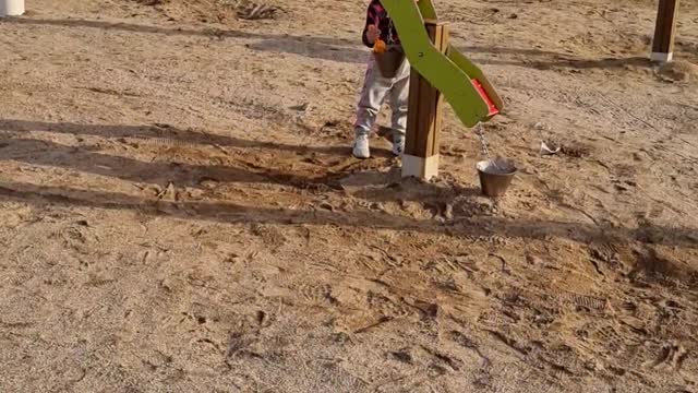 A child playing in the sand