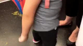 Little girl subway doing the floss with one arm glasses