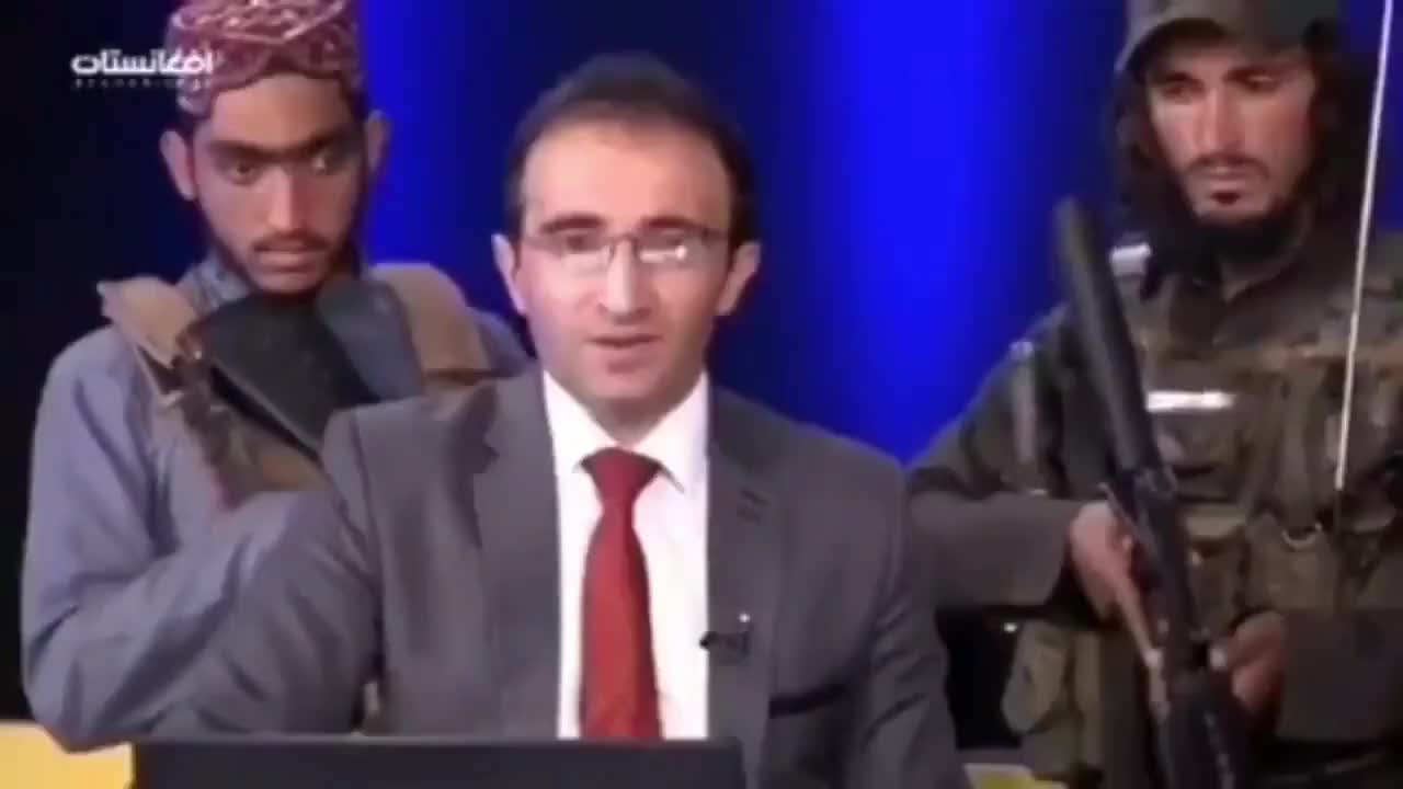 Afghan TV shows armed men behind "Peace Studio" anchorman