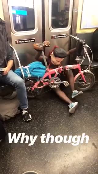 Woman with mask and pink bike pretending to ride on floor