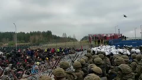 NOW - Large groups of illegal migrants gather at Poland-Belarus border crossing.1