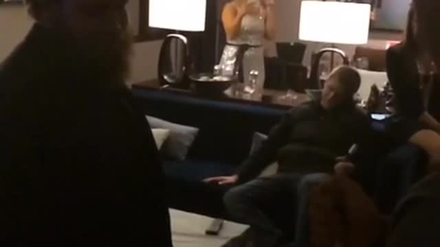 Champaign bottle shoots cork into bearded mans face
