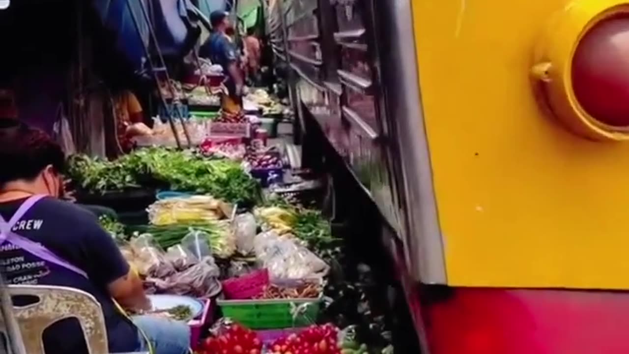 Train passing through food market