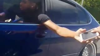 Guy hands off phone from moving car to moving car