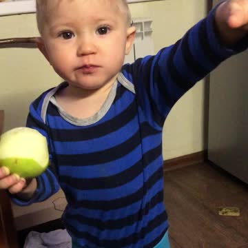 The boy eats an apple very appetizing