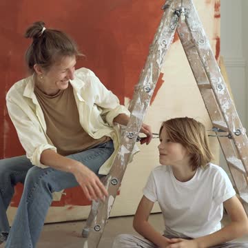 Adult and Child Painting a Wall