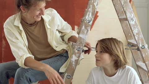 Adult and Child Painting a Wall