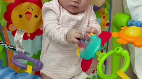 Cute baby trying to grab toys