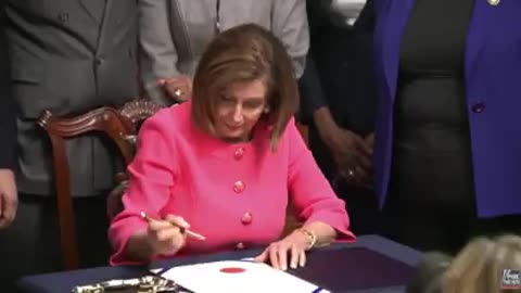 Nacny Pelosi signs each letter with a different pen