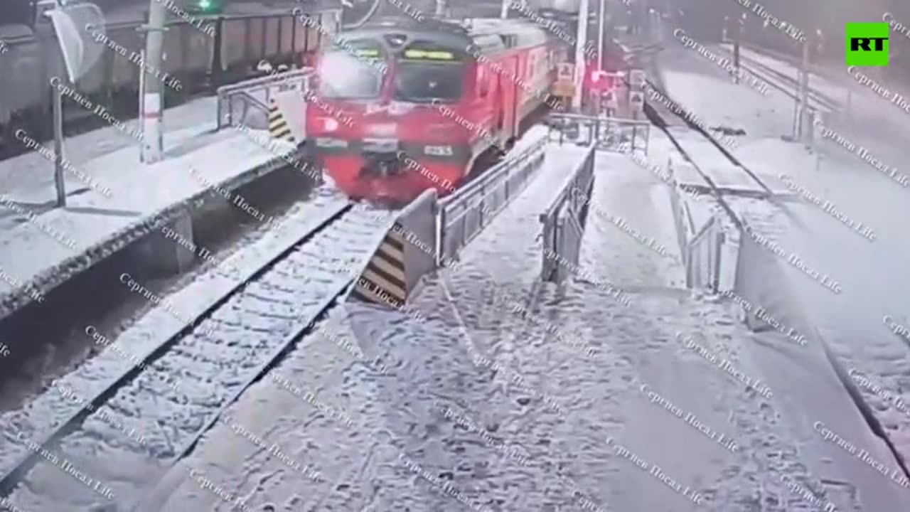 Bizarre moment girl walks in front of moving train