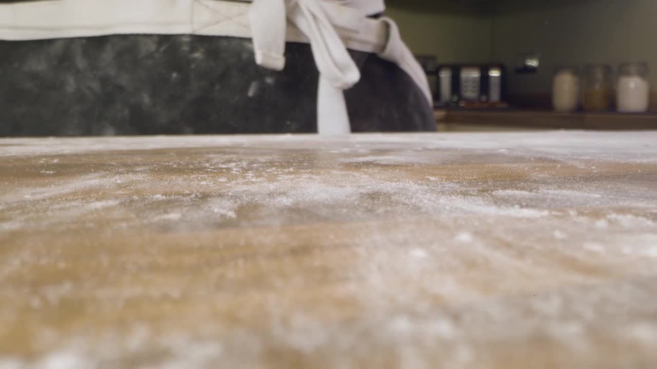 Male Turning Over Dough on Kitchen Worktop