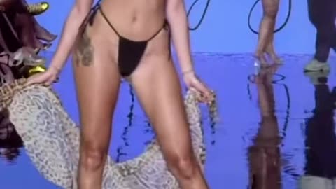 Swimsuit model almost falls on runway