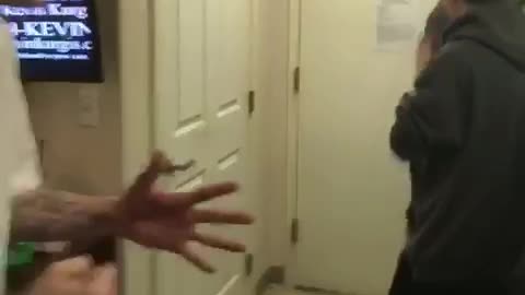 Guy white shirt getting held down trying to fight other guy