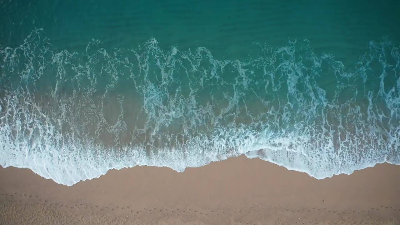 Beautiful waves breaking on golden sand