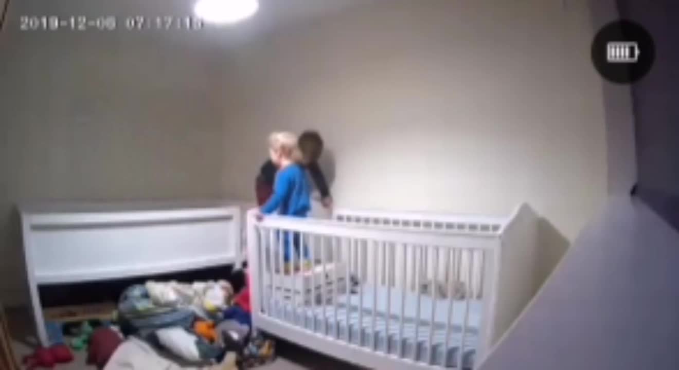 Boy Helps Brother out of Crib