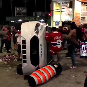 Habs fans flip over a police car after Game 7 win on June 24