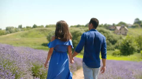 Lovers walking through a lavender field