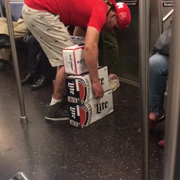A guy in red shirt hat trying to carry beer