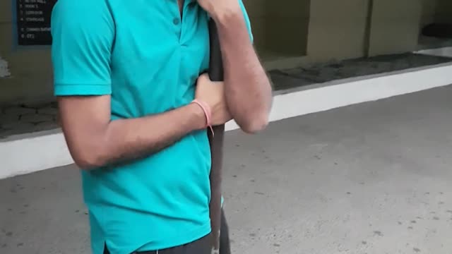 Guy blue shirt swinging on pole