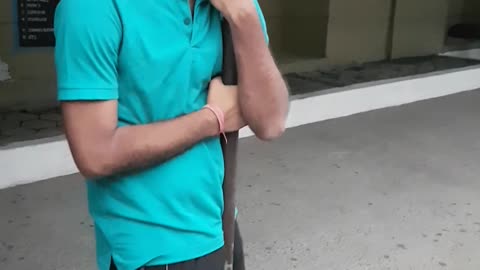 Guy blue shirt swinging on pole