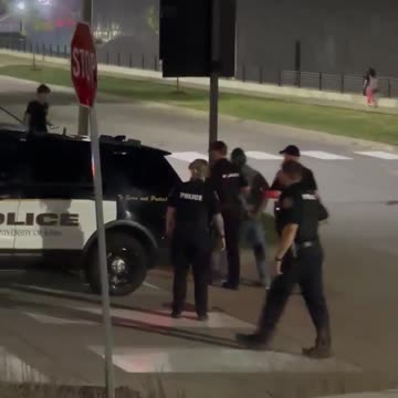 Police take away person who attacked TPUSA event