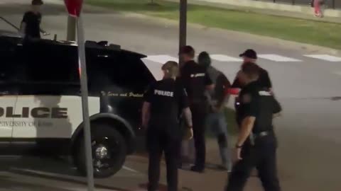 Police take away person who attacked TPUSA event