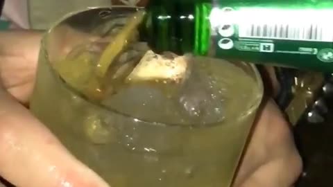 Music guy in nightclub puts finger in drink and spins it around