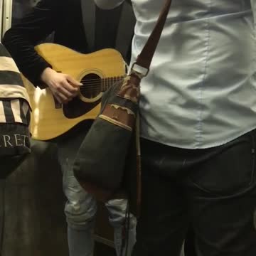 Group of men playing instruments on subway train